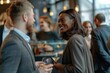 © Baba Images - View of diverse businesspeople at a networking event having conversation