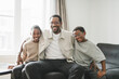 © Louis-Paul Photo - Father and two childs having great time on the livingroom