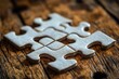 © Ali - Interlocking puzzle pieces on wood surface