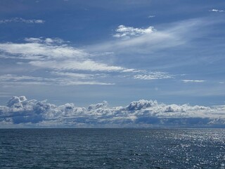 Wall Mural - beautiful shiny ocean and scenic sky clouds