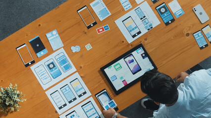 Wall Mural - top view of skilled developer walking and placing ux ui software. smart business man put tablet on m