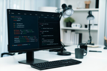 Programming code on computer screen desktop placing on working desk showing intelligent website development coder system running database online with information technology design concept. Infobahn.