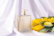 © ADDICTIVE STOCK - Elegant perfume bottle with yellow flowers and white fabric