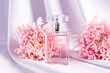 © ADDICTIVE STOCK - Elegant perfume bottle with pink chrysanthemums on silk