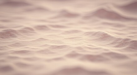 Poster - The image is a close up of a sandy beach with a wave in the background