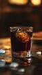 © RaptorWoman - A glass of whiskey with ice sits on a bar, illuminated by warm ambient lighting, creating a cozy atmosphere.
