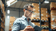 © Peachaya - A man stands in a warehouse with a tablet computer, checking inventory statements for the presence of goods. The concept of logistics, supply chain management, and digital inventory control.