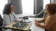 © Krakenimages.com - Doctor consulting mature patient in a clinic room, highlighting healthcare interaction between two hispanic women in a professional medical workplace setting indoors.