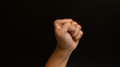 © Krakenimages.com - Clenched fist of a man against a dark background shows strength, determination, and power.
