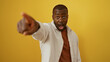 © Krakenimages.com - Young man pointing with an expressive face over an isolated yellow background, conveying surprise and excitement