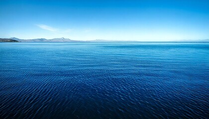 Wall Mural - the image is of a calm body of water with a blue color