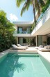 © Viktor - Luxury modern villa with outdoor swimming pool, lounge area and tropical garden. Private house with water pool, sunbeds and plants. Vacation home, resort, spa. Contemporary architecture design.