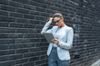 © Srdjan - Portrait of a successful business woman using digital tablet in front of modern business building. Businessperson office worker design professional occupation, innovative work outside of workspace.