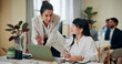 © peopleimages.com - Business women, laptop and discussion in office for advice, training and problem solving. Administration, female manager and tech in agency for feedback, help and assistance with learning software