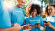 © FremeFlex/peopleimages.com - Volunteers, charity and people with phone, outdoor and communication for fundraising event or online. Happy, social responsibility and group with tech for donations, browsing and community service