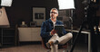 © Flashizzle24/peopleimages.com - Live stream host, talk show and man with tablet in home studio for documentary interview or online podcast. Filming set, lights and mature journalist with digital script for recording and news update