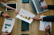 © we.bond.creations - Business team analyzing financial charts and graphs during a corporate meeting