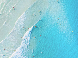 Wall Mural - aerial view on beach and people. vacation and adventure. top view from drone at beach and azure sea.
