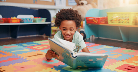 Aufkleber - Boy, reading book and education on floor in classroom for development, storytelling or knowledge at academy. Child, learning and study for scholarship, smile or info with course at elementary school