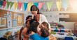 © peopleimages.com - Happy, care and children hugging teacher in classroom for bonding, learning and thank you. Love, kids or students embracing woman educator for greeting in morning for lesson at elementary school.