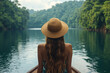 © Bohdan - Woman enjoys tranquil boat ride on serene lake