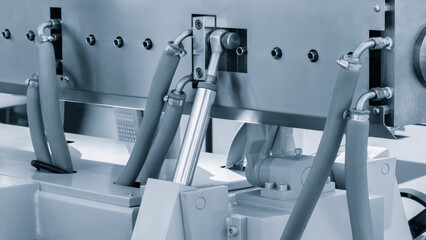 Poster - A machine with a lot of hoses and a lot of bolts. The bolts are silver and the hoses are blue