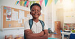 © Jess B/peopleimages.com - Arms crossed, happy and education with black boy in classroom for learning, future and youth. Scholarship, academy and growth with portrait of kid in school for child development, knowledge or lesson