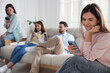 © New Africa - Internet addiction. Group of people with smartphones on sofa indoors, selective focus