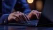 © Boke - Businessman working late at night on laptop computer keyboard