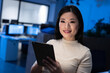 © Wavebreak Media - In office at night, businesswoman confidently using tablet for work