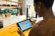 © Wavebreak Media - African American woman using tablet to monitor energy usage in modern kitchen