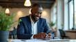 © HaJung - Portrait of happy African business man employee or student using smartphone at work smiling young adult male professional worker holding cell phone smart mobile tech working in office sitting at desk