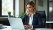 © HaJung - Flat Vector Illustration of a Mature Businesswoman in Office: HR Manager Reviewing Financial Tax Reports and Documents on Laptop in a Professional Consultancy Setting