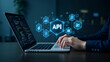 © HaJung - Hand Coding on Laptop: Interacting with Holographic API Development Icons in Empty Space - A Unique Photo Stock Concept for Innovative Programming Visuals