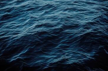 deep, dark blue ocean waves. close-up view of the water's surface, showing the textured pattern of r