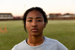 © Wavebreak Media - Determined female athlete standing on rugby field during sunset, ready for practice