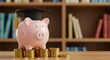 © Pambudi - A pink piggy bank wearing a graduation cap sits on a pile of coins in a library, symbolizing education savings, financial planning, and student investment for the future.