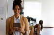 © Wavebreak Media - In office, businesswoman standing confidently holding tablet, smiling at camera, copy space