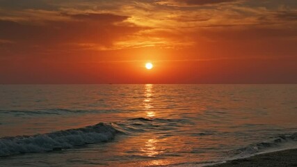 Wall Mural - stunning sunset over sea with vibrant colors reflecting on the water at the beach, 4k