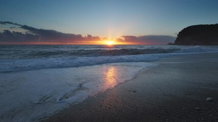 Wall Mural - stunning sunset over sea with vibrant colors reflecting on the water at the beach, 4k