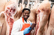 © littlewolf1989 - Experienced meat industry worker checking quality of pork meat in slaughterhouse.