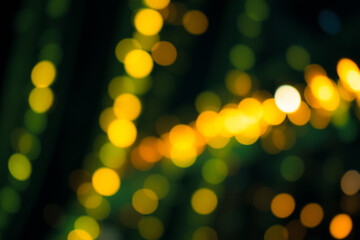 Aufkleber - Blurred yellow lights against a dark green backdrop create a soft bokeh effect. The image evokes a warm, festive, and dreamy atmosphere with its out-of-focus circular lights.