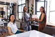 © Wavebreak Media - Smiling diverse women celebrating business achievement with certificate in modern office