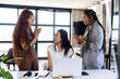 © Wavebreak Media - Diverse female colleagues celebrating success around laptop in modern office, sharing joyful moment