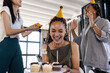 © Wavebreak Media - woman celebrating birthday at office with cupcakes and friends