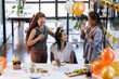 © Wavebreak Media - Female diverse colleagues celebrating birthday with cupcakes and balloons in modern office