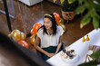 © Wavebreak Media - Asian woman celebrating birthday at office with cupcakes and festive balloons