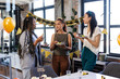 © Wavebreak Media - Female diverse colleagues enjoying birthday celebration with cake and balloons in modern office