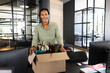 © Wavebreak Media - Smiling man unpacking box at new office desk, ready for work