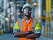 © taweesak - Man wearing safety vests and goggles in an isolated environment with refinery infrastructure in the background